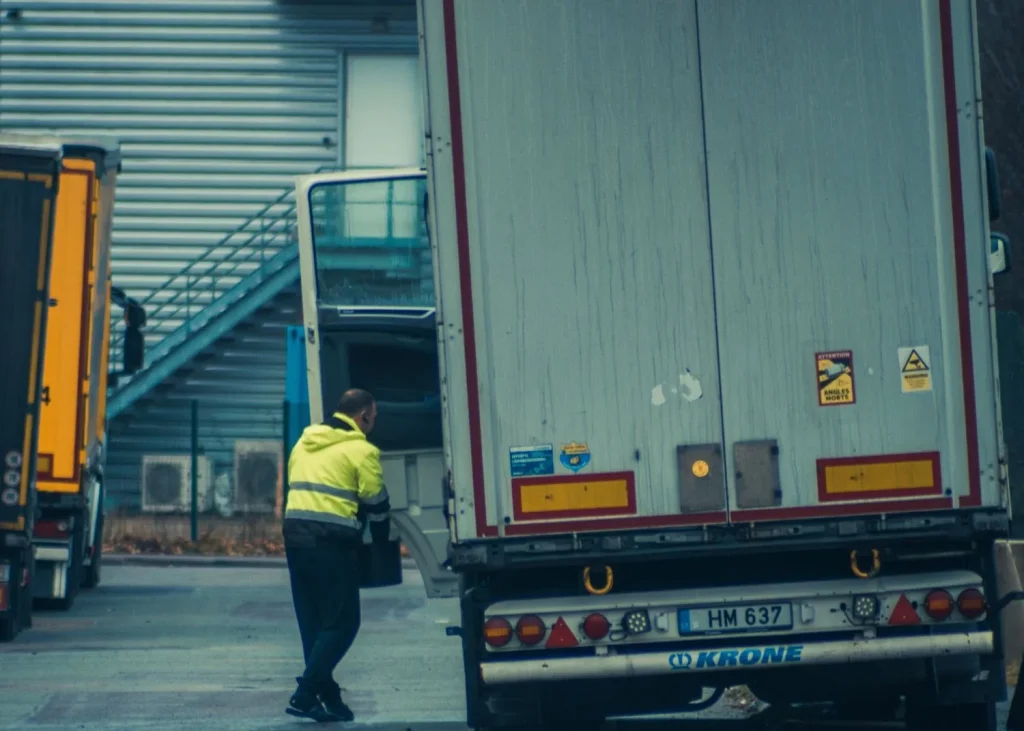 Safety-compliant driver unloading cargo at a freight facility
