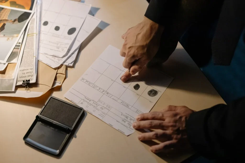 Fingerprint capture station with ink pad and identity documents