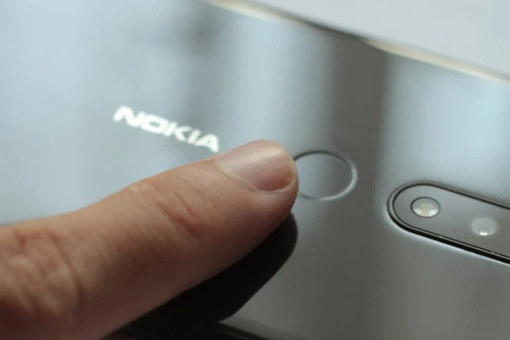Finger placed on a digital fingerprint sensor for electronic capture