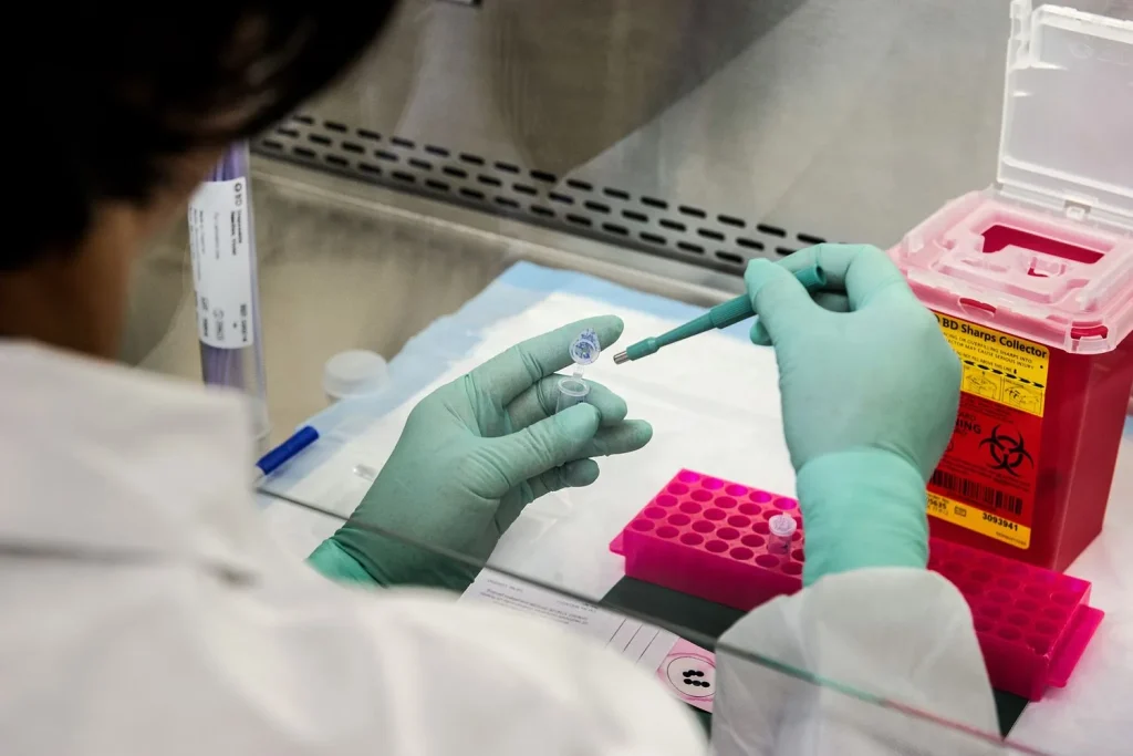 Technician processing employer drug screens in a sterile lab