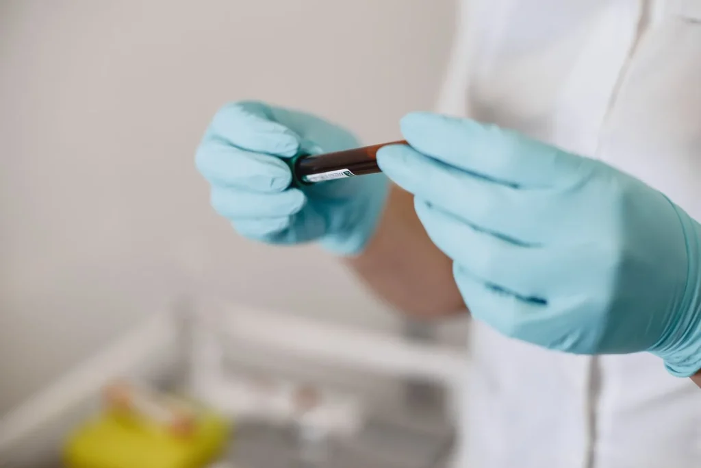 Laboratory technician verifying a labelled specimen vial